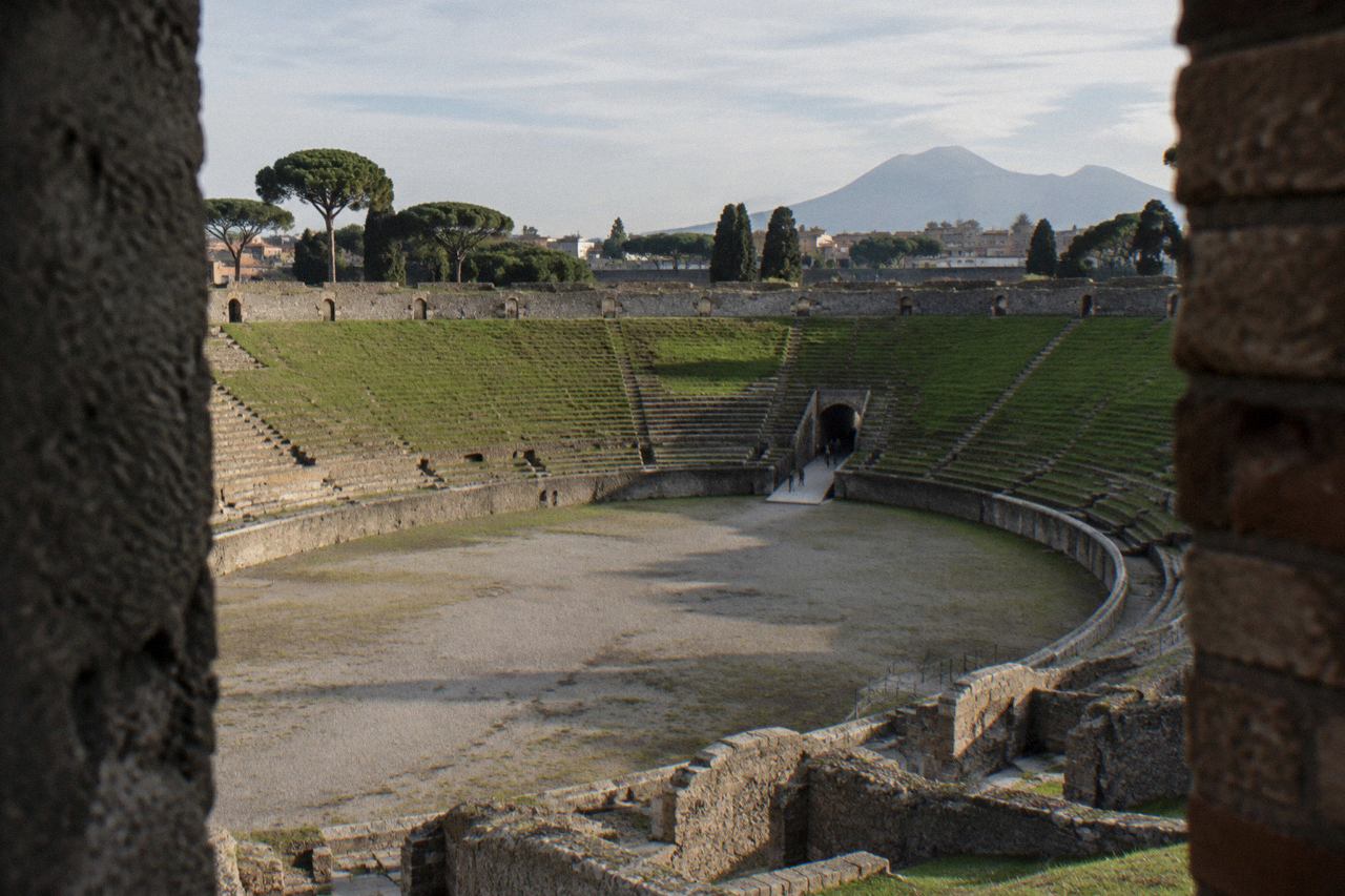 Ancient stone street in Pompeii with worn cart ruts and ruined walls under a clear sky